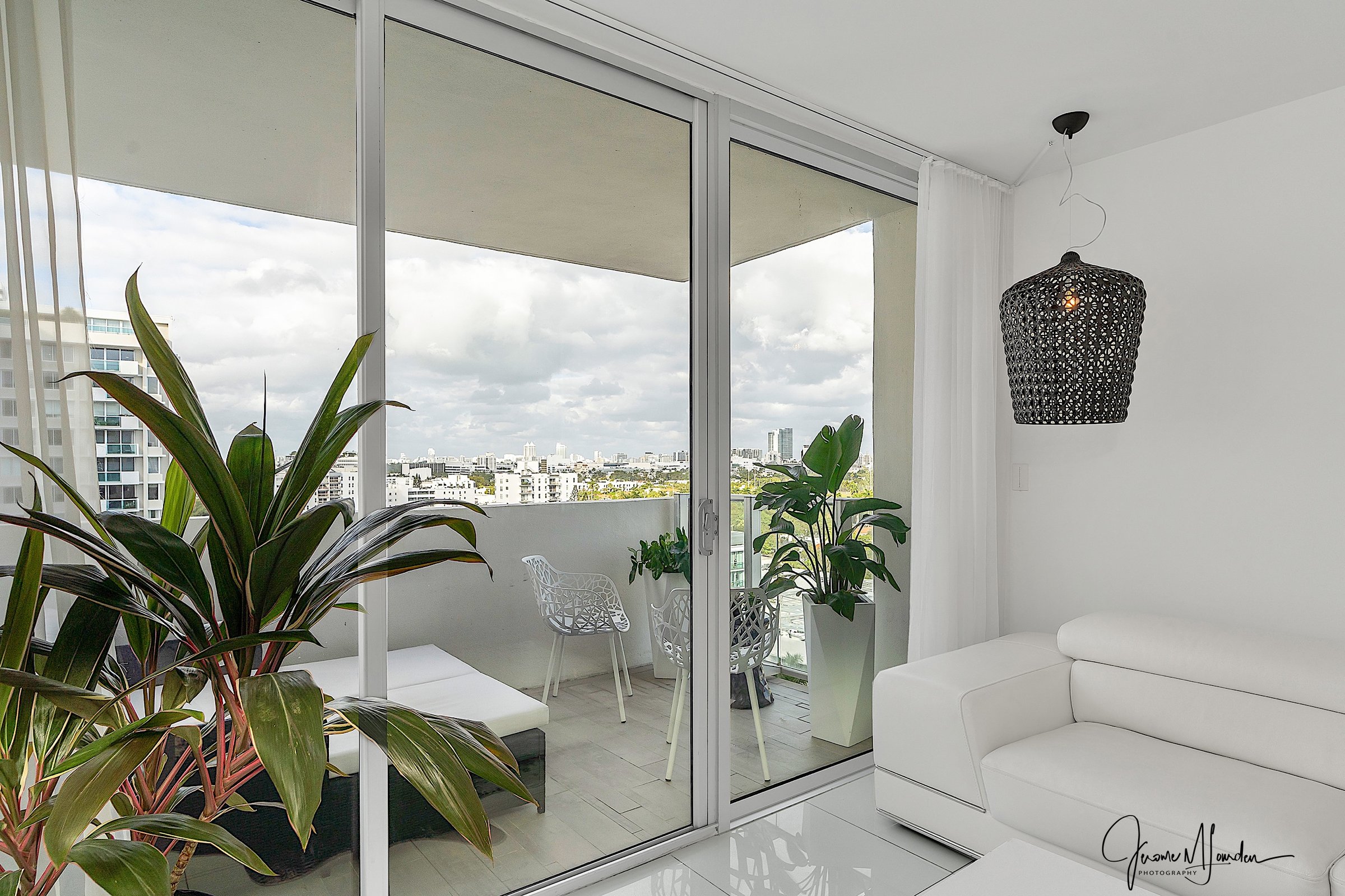 Balcony access with pendant lamp and city views